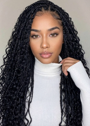 Woman with long black braided hair wearing a white turtleneck sweater.